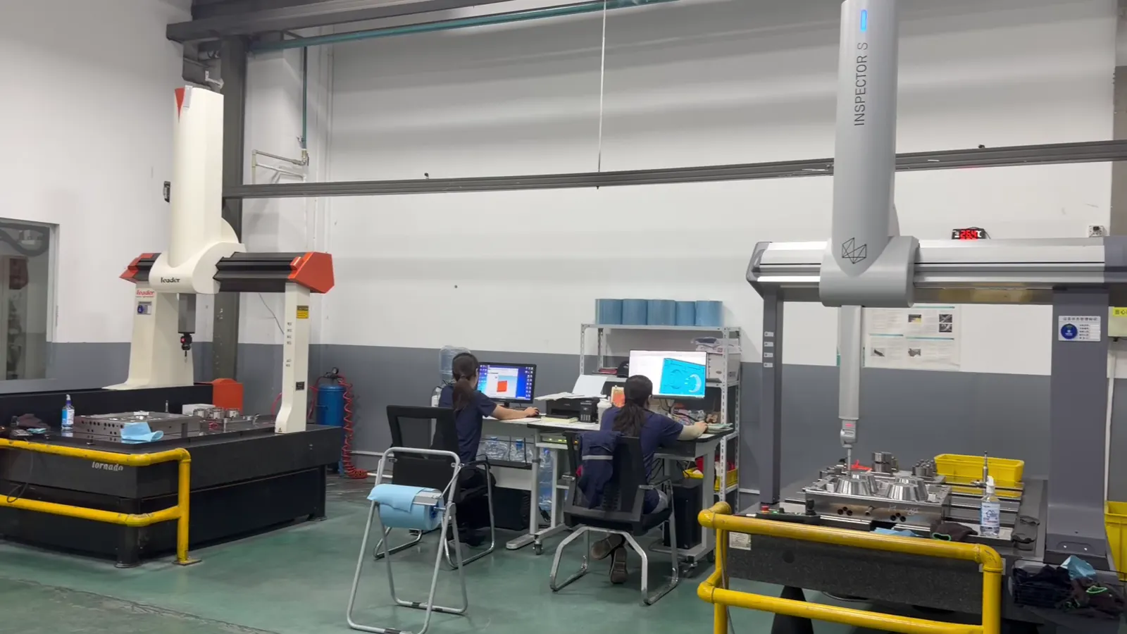 Two CMM systems and inspectors in Hengqi's measurement room