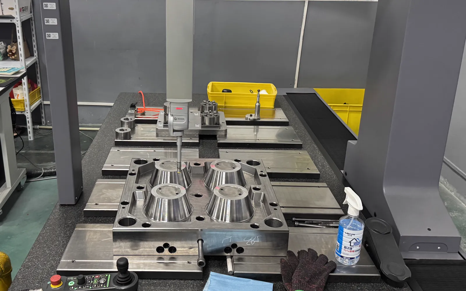Close view of CMM probe measuring a four-cavity mould component